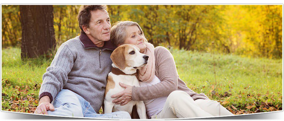 A couple enjoying the outdoors with their dog